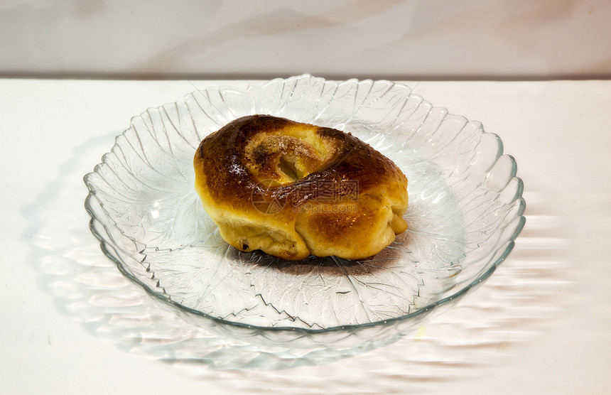 甜甜的滚动躺在玻璃盘里食物烘烤早餐黄色烹饪棕色小麦馅饼面包白色图片