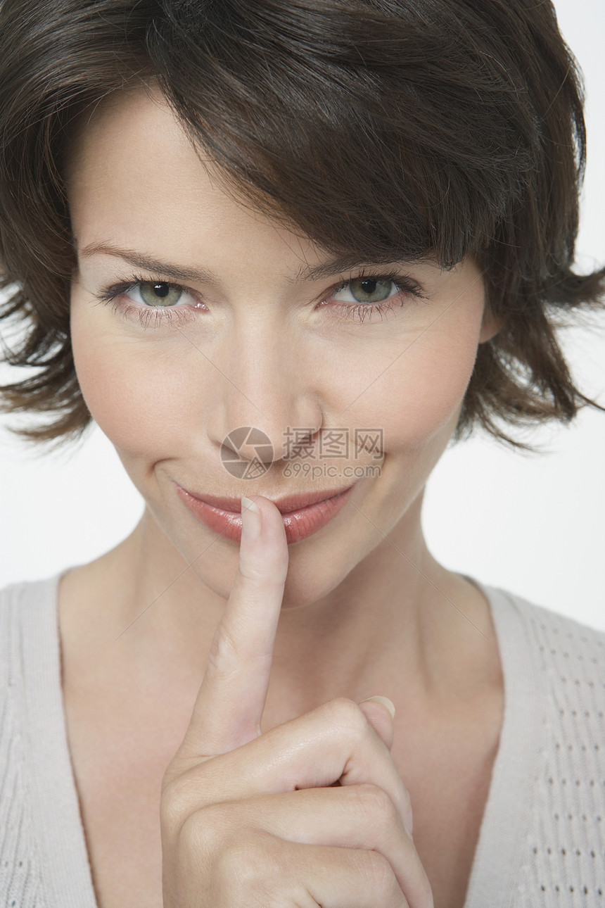 紧贴一个阴险的女人 用手指在嘴唇上图片