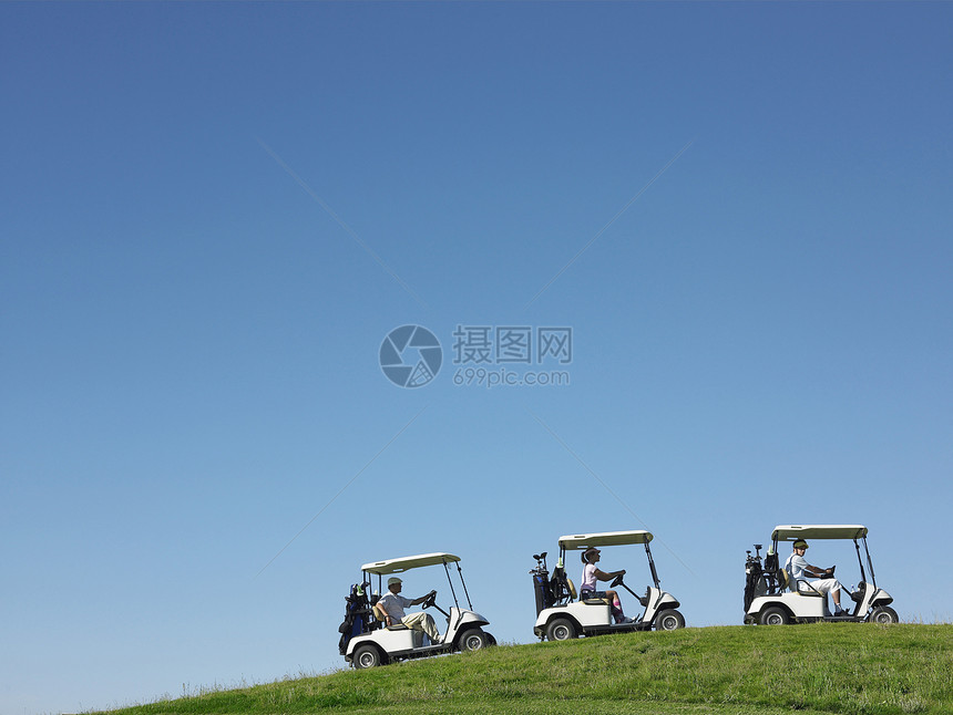 高尔夫车在蓝色的天空中排行驾驶推车播放器课程运输高尔夫球男士女士游戏爱好男人男性图片