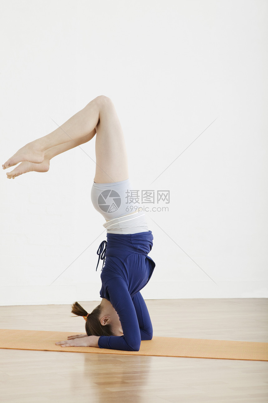 少女1617岁头顶平衡拉伸赤脚运动锻炼灵活性力量棕色服装体操运动垫图片