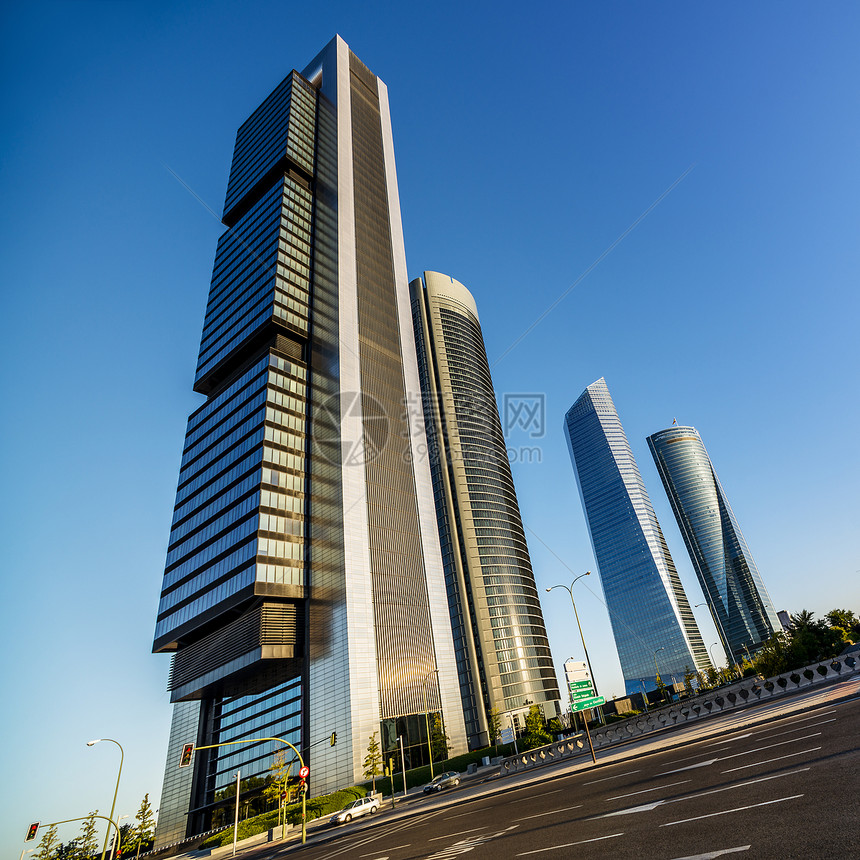 四座现代摩天大楼日落天空玻璃反射太阳高度阳光金融正方形城市图片