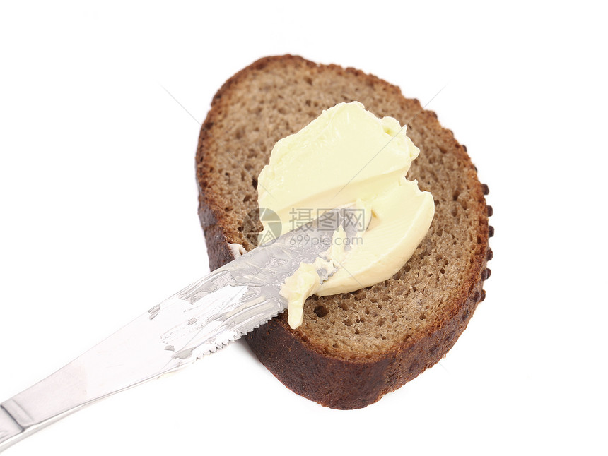 棕色面包上的黄油刀粮食传播用具食物小麦营养白色盘子小吃黄油图片