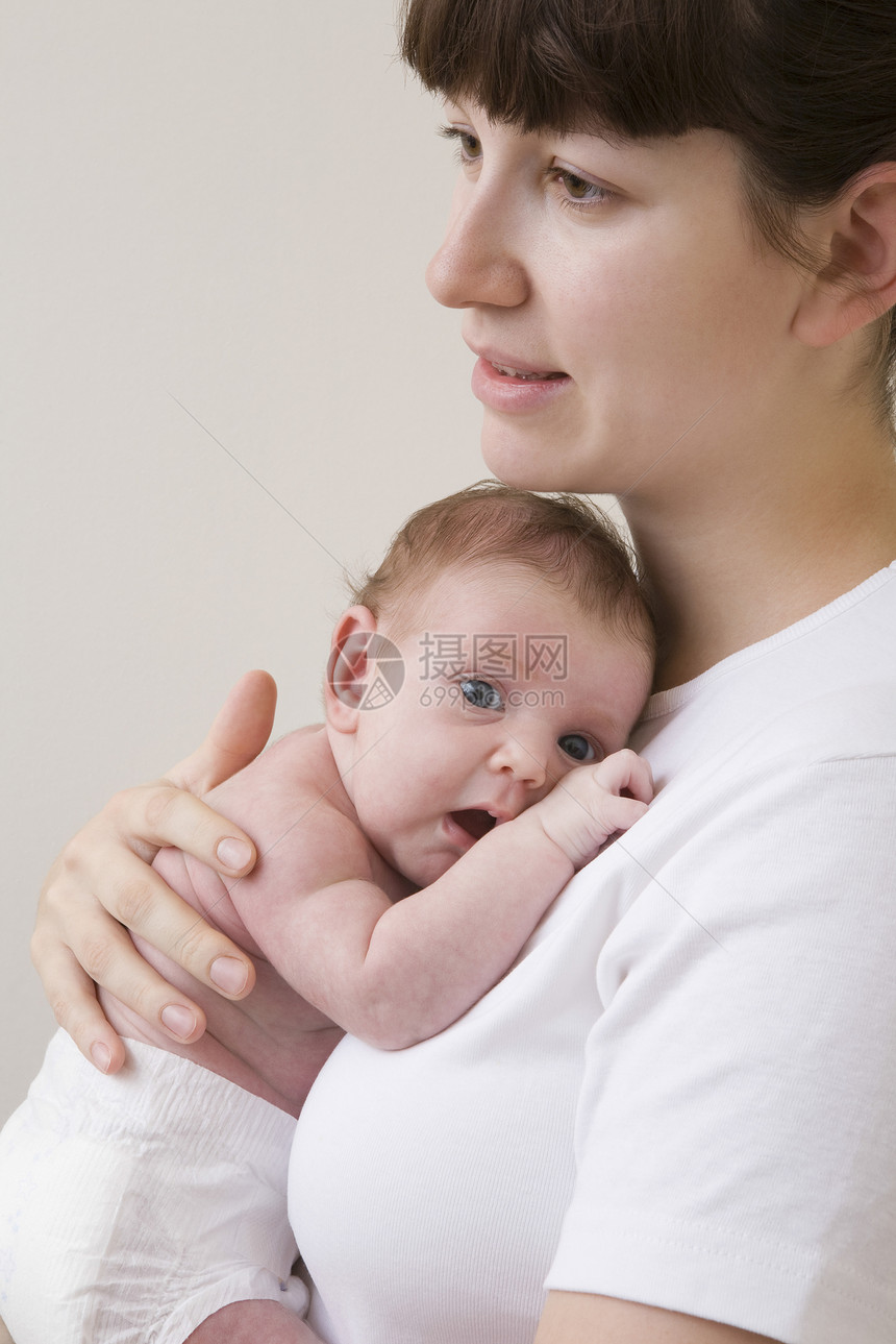 母亲拥抱新生婴儿工作室的肖像拍摄孩子视图成年头肩影棚漏洞宝贝男孩关爱女婴图片