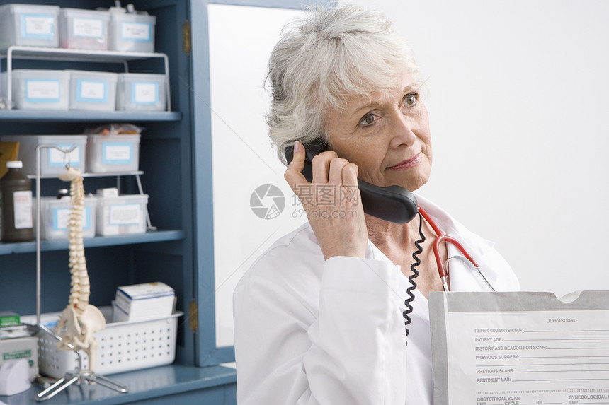 高级执业医师在医疗内阁的电话上站立图片