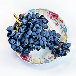 爆珠蓝莓盘子里的葡萄水果食物甜点叶子树枝饮食浆果果汁蓝色维生素背景