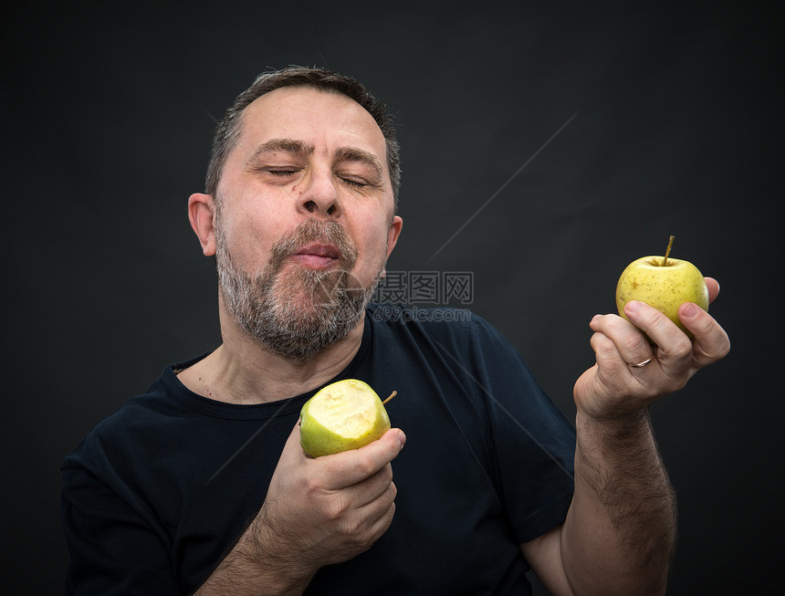 带绿苹果的中年人享受营养水果饮食胡须生活食物胡子男性食欲图片