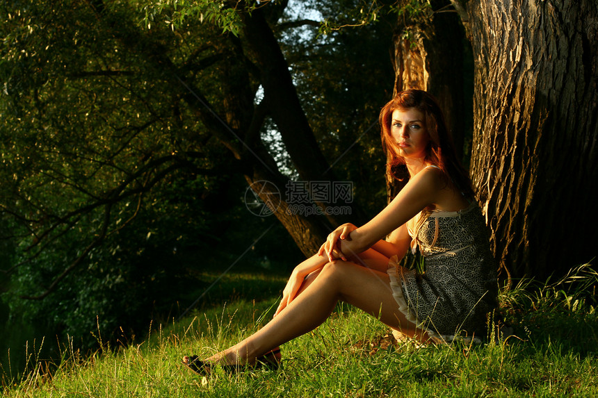 坐在林中树下年轻美丽的女士 坐落在树下成人微笑化妆品花园公园幸福喜悦女孩情调异国图片
