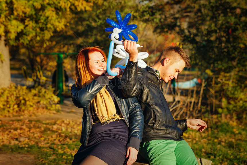 秋天公园的一对夫妇玩具乐趣女性福利花朵友谊享受浪漫公园花期图片