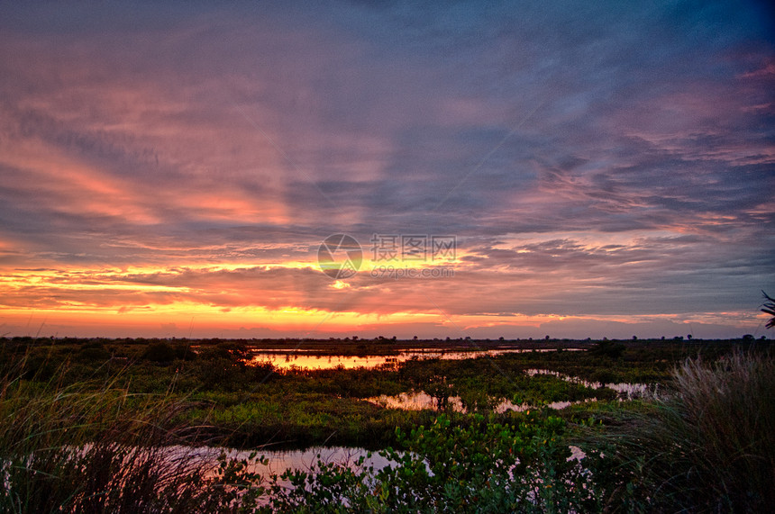 日落天空目的地橙子沼泽地太阳风景海洋场景旅游摄影图片