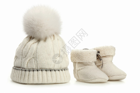 鞋衣服素材温暖的羊毛婴儿帽和靴子在白色之上背景