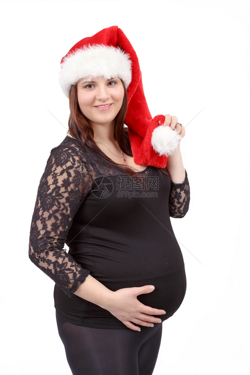 怀着肚子的美丽的孕妇 幼小地将她的肚子隔离在图片
