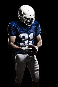 足球远动员足球运动员文化男性职业力量成人蓝色制服头盔肌肉动员背景