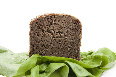 沙拉叶上的全食面包早餐产品粮食绿色烘焙背景图片