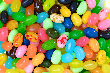 Jelly Bean 果冻豆黄色紫色甜食粉色糖果食物饮食小吃橙子绿色背景图片