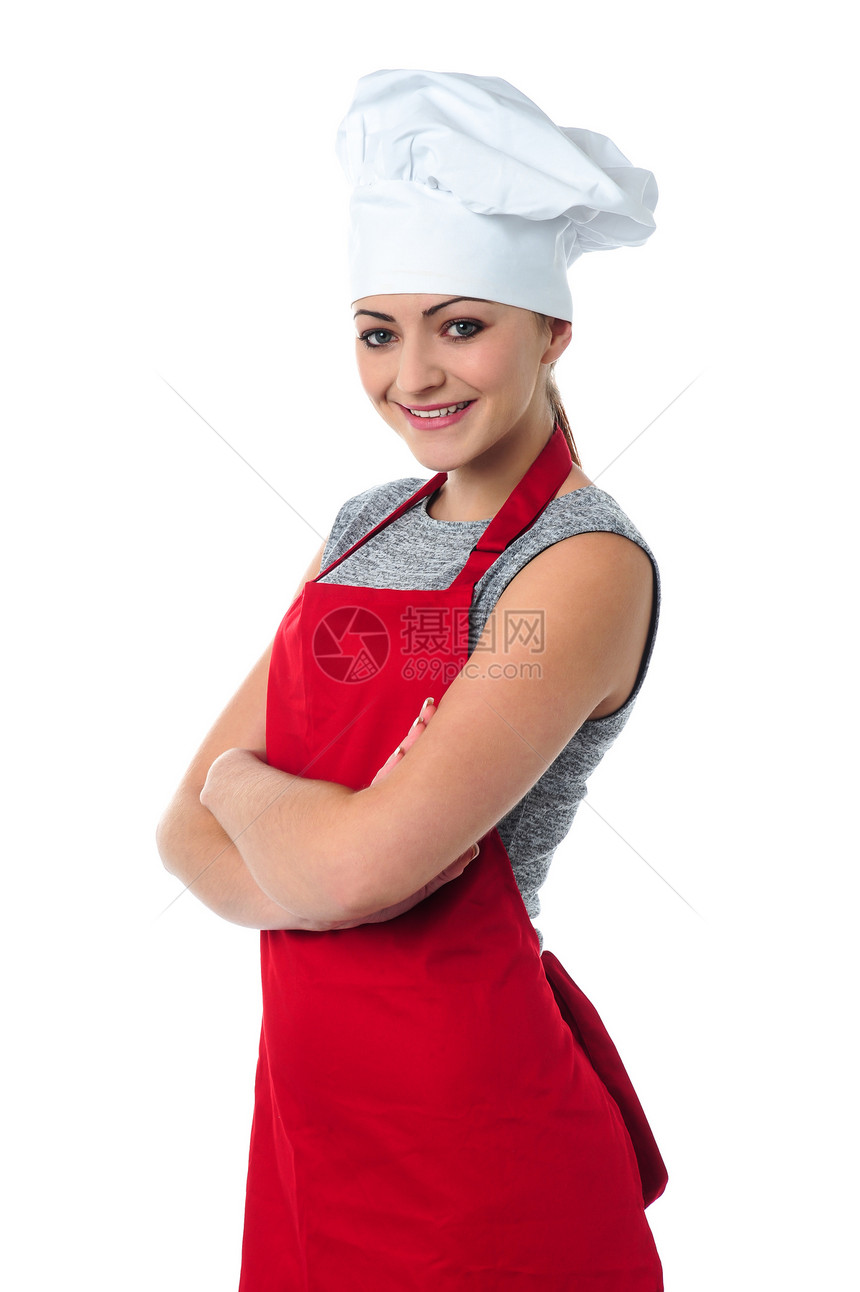 自信的年轻女厨师食物工作室转矩面包师餐饮工作快乐双臂商业厨房图片