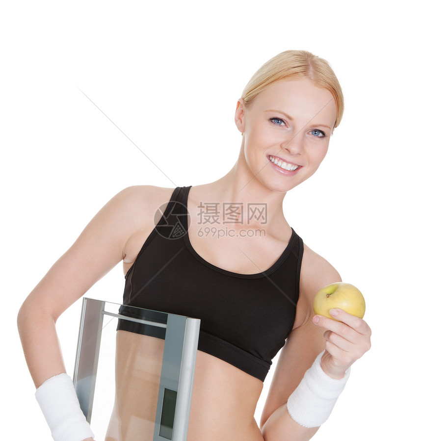配有重量和苹果的适合身体的妇女女性食物火车喜悦女士水果健身房营养女孩运动图片