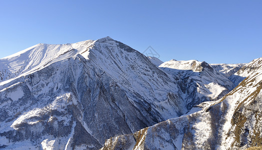 格鲁吉亚高加索山 高加索山岩石古道天空旅行太阳顶峰阳光蓝色背景图片