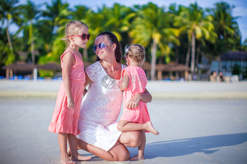 热带白沙滩上可爱的小女孩和年轻母亲假期海洋女孩海岸线享受海岸孩子父母女士家庭图片