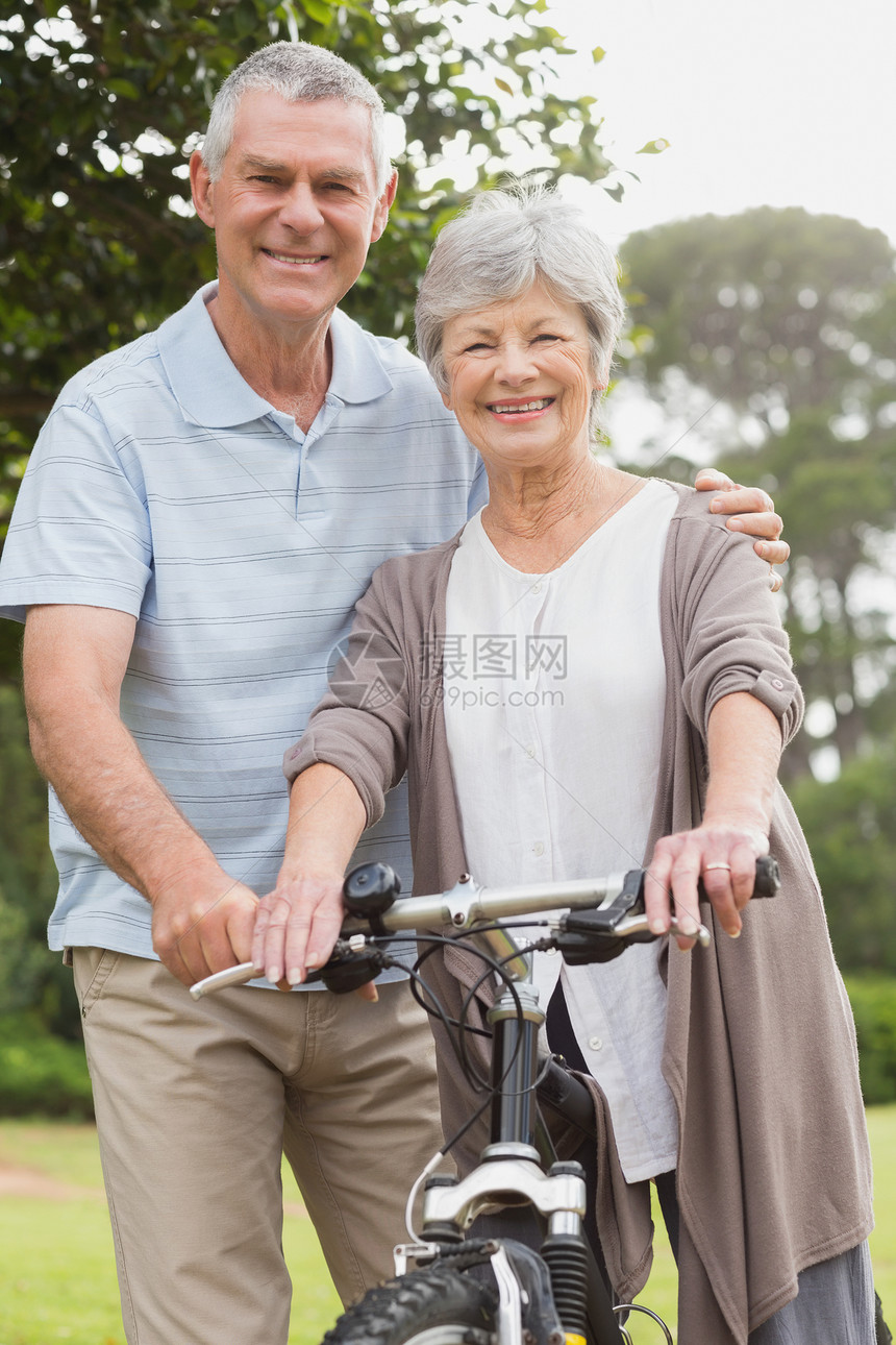 在公园骑自行车的年长夫妇锻炼闲暇男人夫妻人员灰色男性亲热头发成人图片