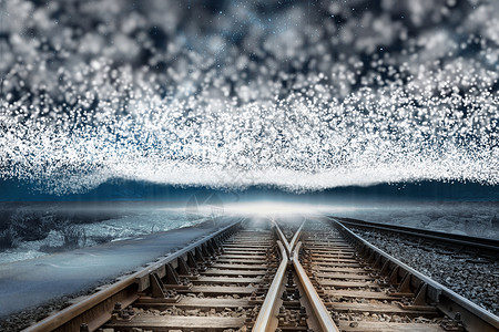在明亮星星的毯子下的火车轨迹背景图片