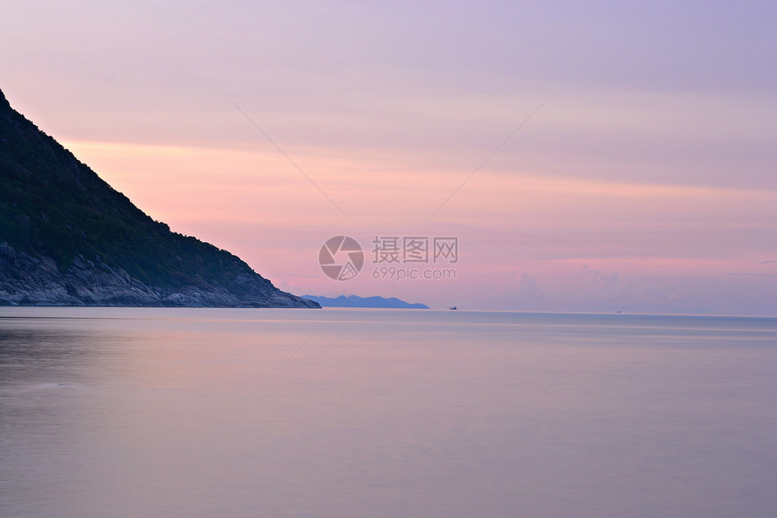 热带热带沙滩上日落气候水面岩石运动季风日出假期目的地海景海滩图片