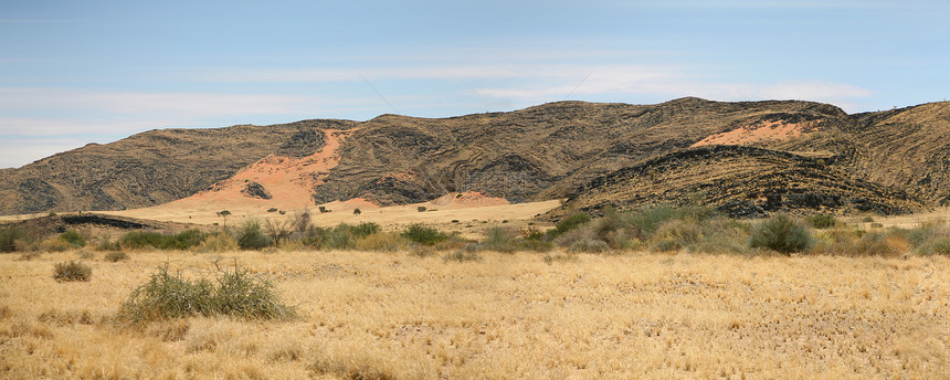 纳米比亚的荒野风景草地爬坡岩石环境纳米布干旱土地孤独沙丘图片