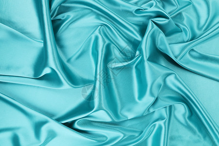 蓝丝床单粉色丝绸织物材料编织衣服窗帘蓝色背景图片