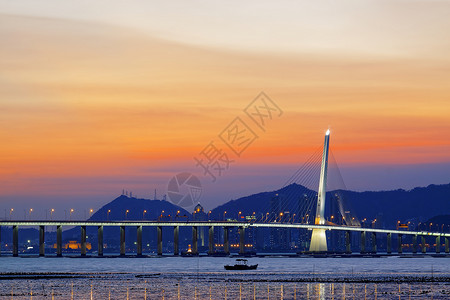 日出过长桥天际海洋码头天空晴天城市阳光旅游橙子地平线背景