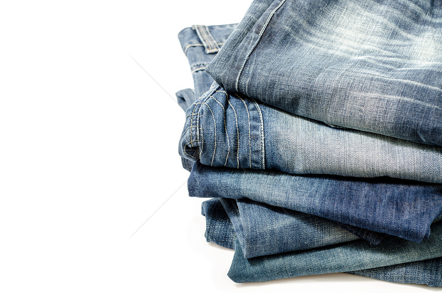 蓝蓝色牛仔裤堆叠材料纺织品宏观口袋单线棉布纹理牛仔布衣服棉纺厂图片