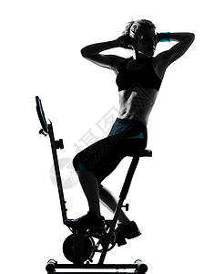 妇女骑自行车锻炼健身运动姿势有氧运动健美训练女性女士机器白色运动员阴影背景图片
