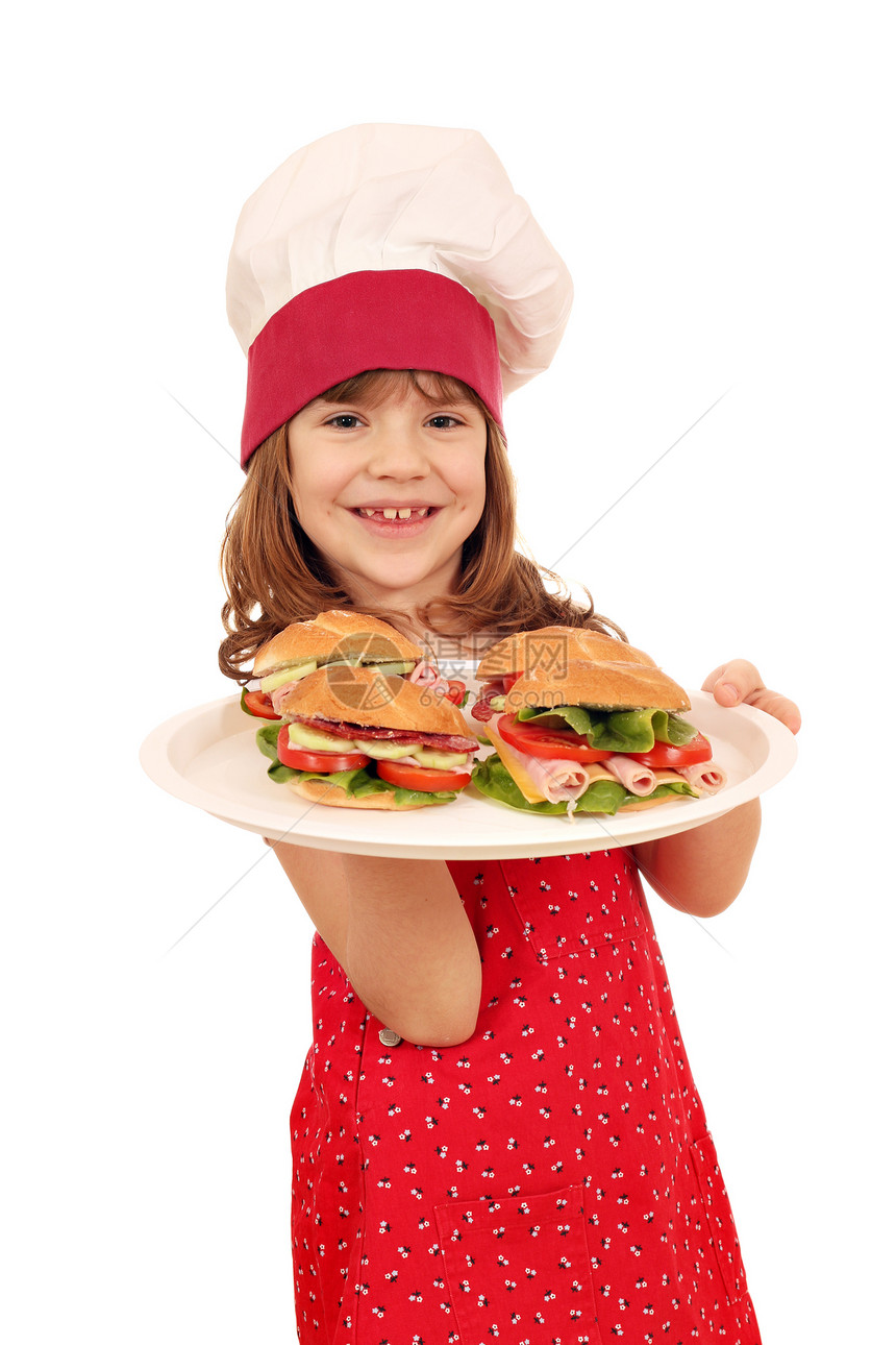 快乐的小女孩煮三明治和三明治图片