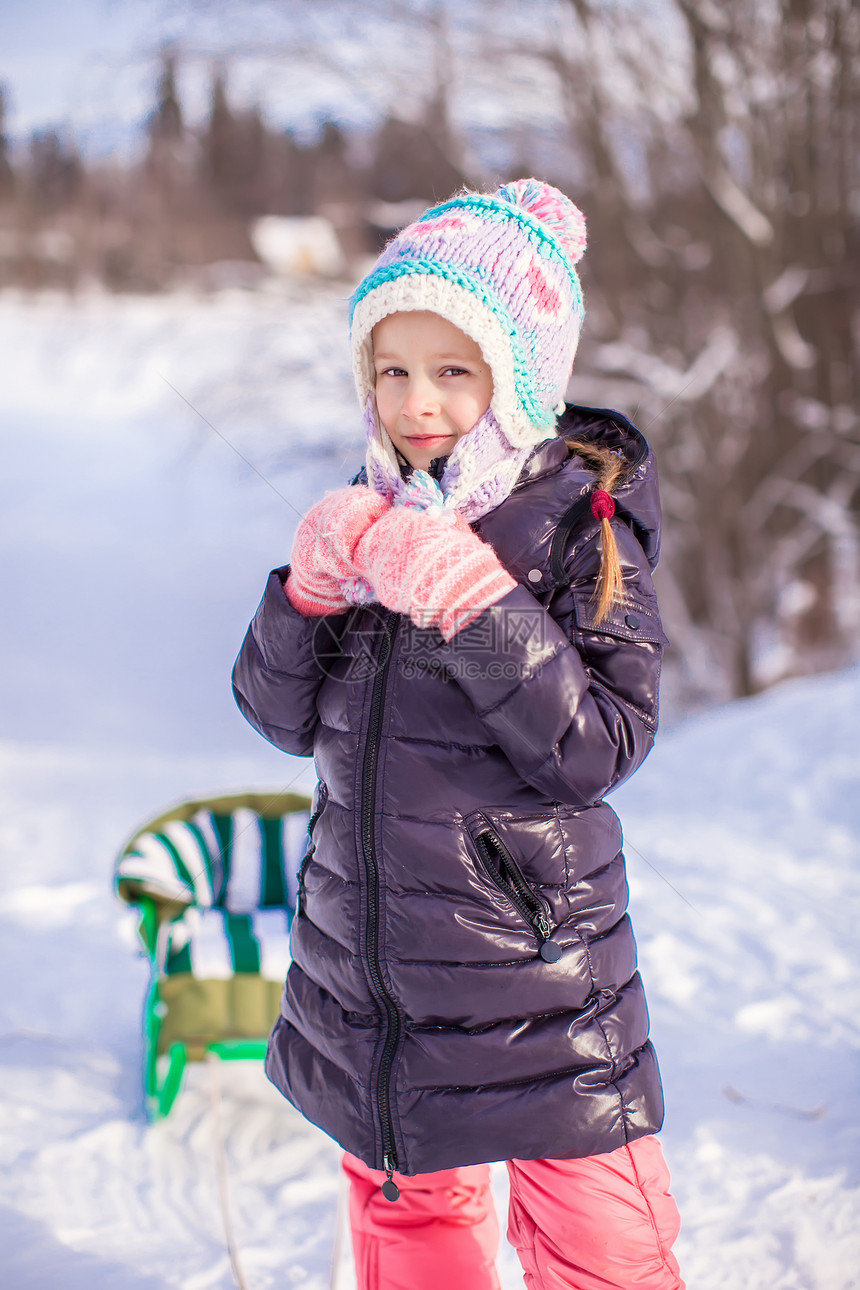 小可爱的快乐女孩 在雪中阳光明媚的冬日图片