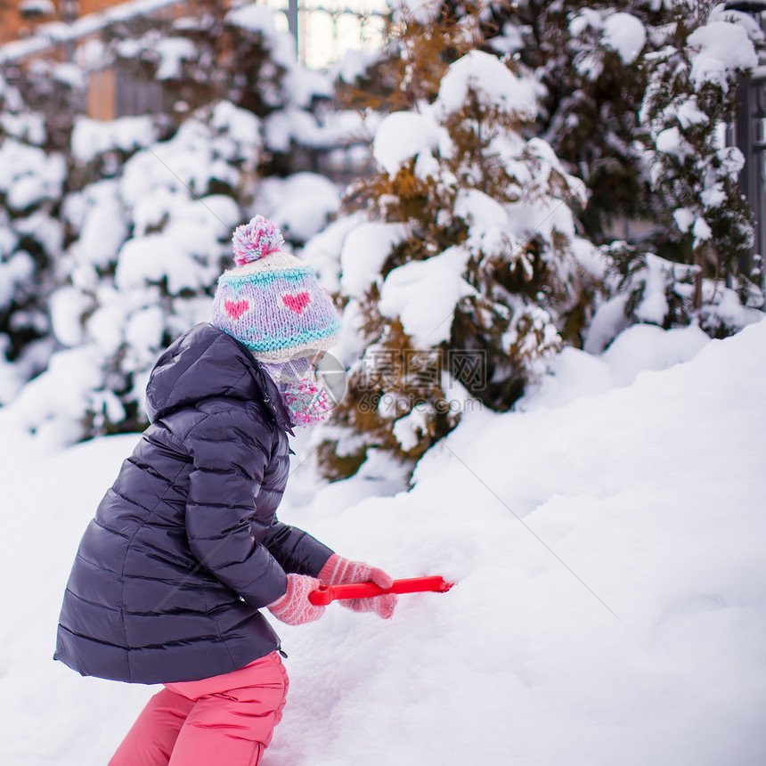 可爱的小女孩玩雪铲雪 在冬日打滚雪堆孩子女性童年快乐微笑闲暇婴儿公园雪花图片