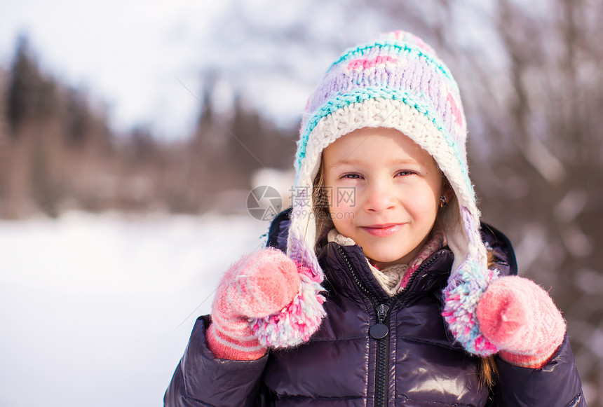 在阳光明媚的冬天天雪中 可爱快乐女孩的肖像季节帽子眼睛童年衣服公园喜悦孩子草地雪花图片