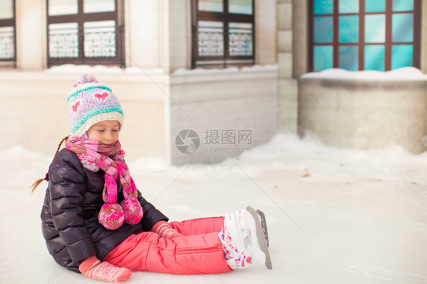 秋天后 可爱的小女孩坐在冰上 穿着溜冰鞋坐着冰雪冰鞋滑冰场运动教学锻炼爱好喜悦活动女性溜冰场图片