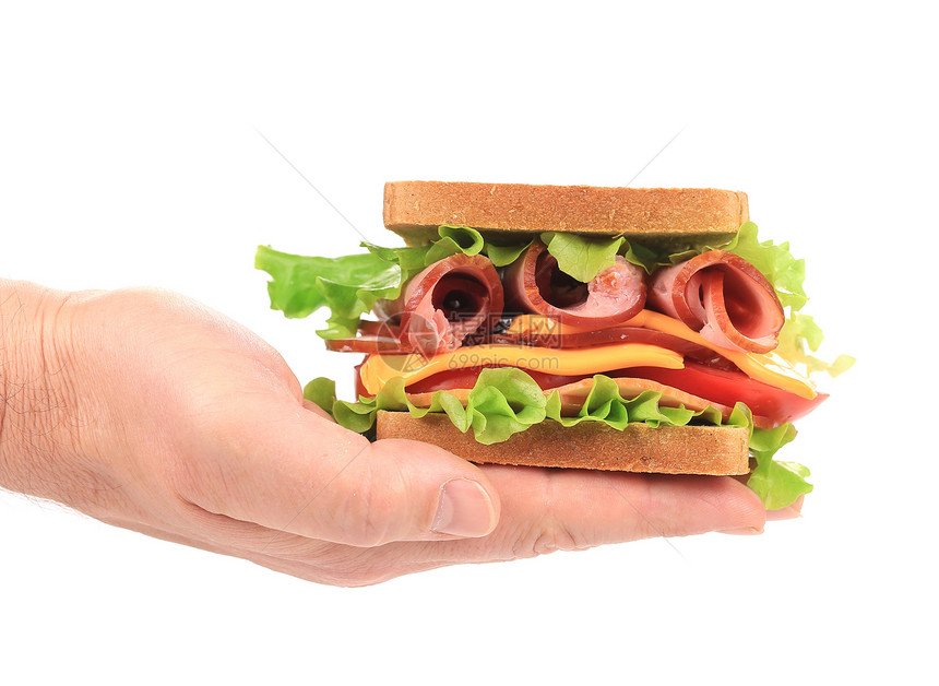 新的大三明治在手里熏制火腿小吃种子垃圾沙拉芝麻蔬菜食物面包图片