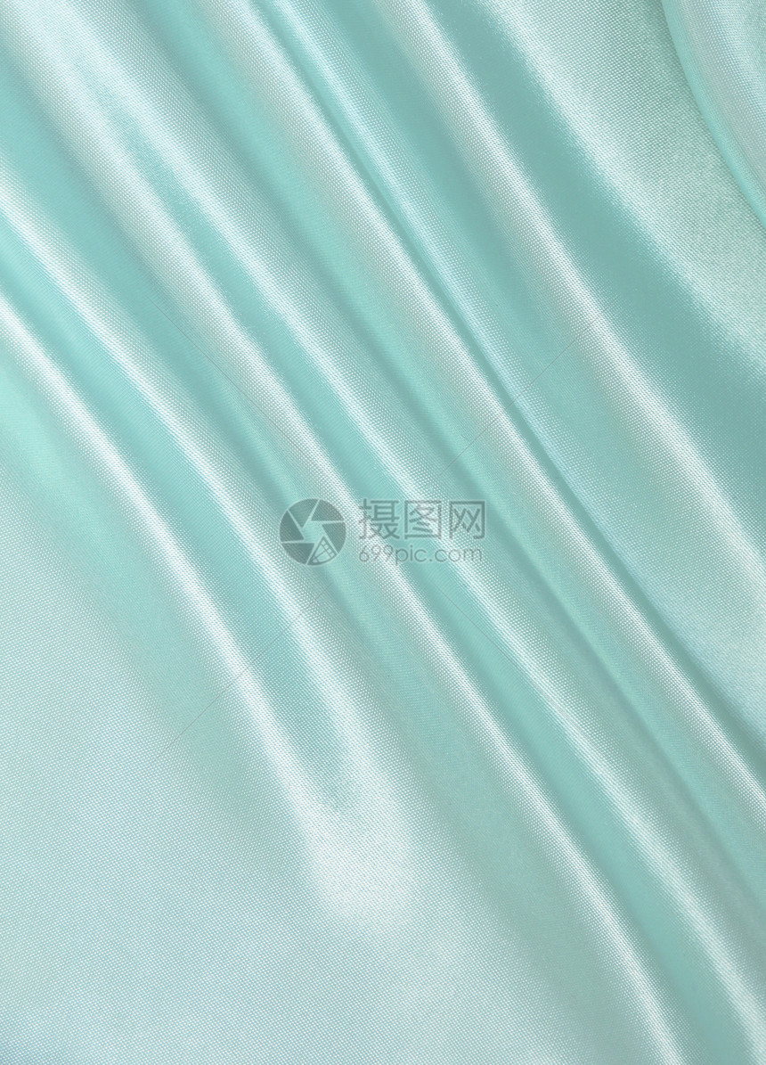 平滑优雅的蓝色丝绸作为背景银色材料织物曲线折痕投标纺织品海浪布料图片