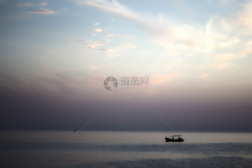 日落海景城市地平线戏剧性阳光紫色蓝色海浪日出海滩场景图片