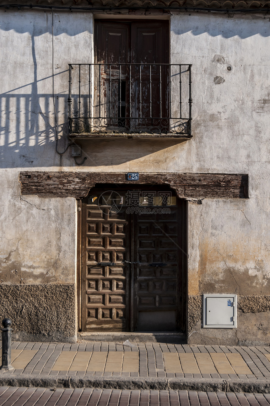 在典型的西班牙街道 农村景象中 古老的门安全房子建筑栅栏历史性石头教会木头入口古董图片