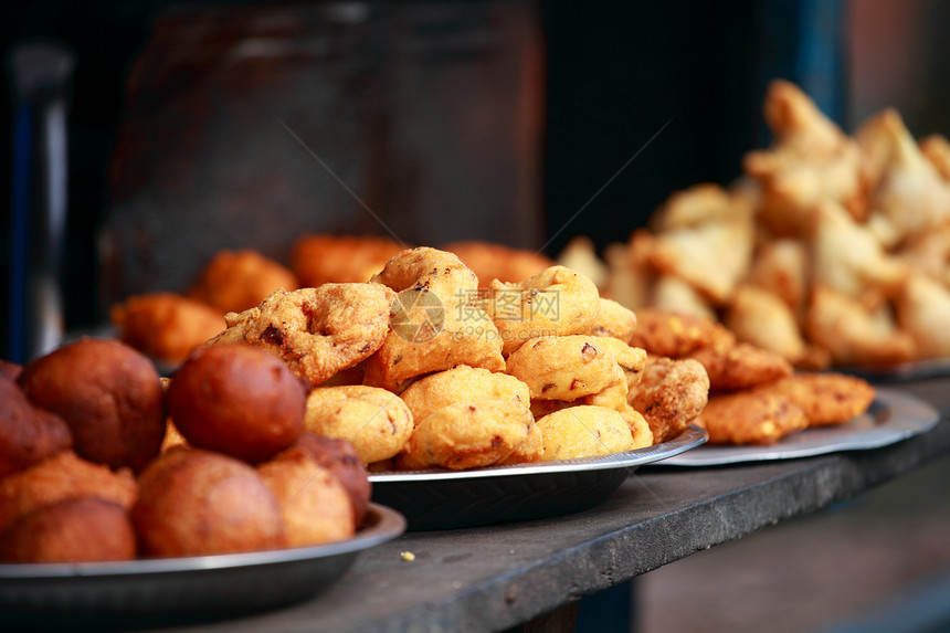 印度传统食物在街上摊位餐厅小吃活动零食橙子销售商品饼子厨房图片