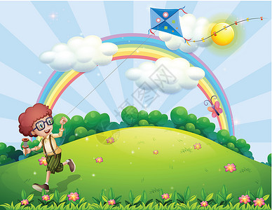 中午的天空一个男孩在山顶用彩虹 玩风筝设计图片