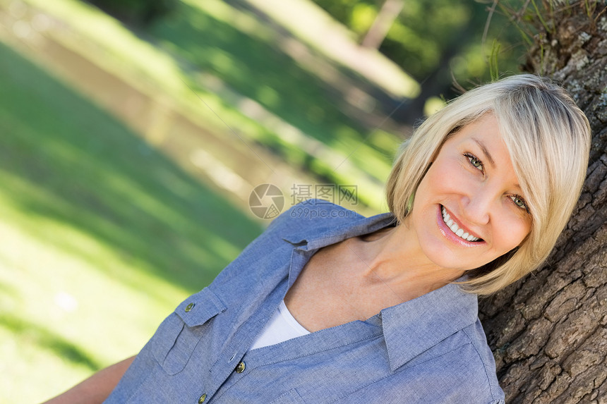 公园中美丽的女人女性头发便服短发空闲闲暇倾斜农村绿地树干图片