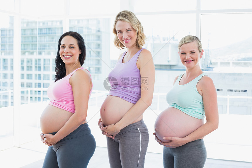 幸福的孕妇站立一排图片