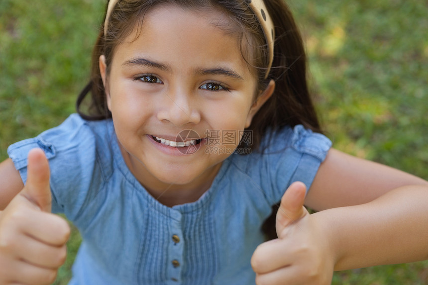 年轻女孩在公园时伸出拇指图片