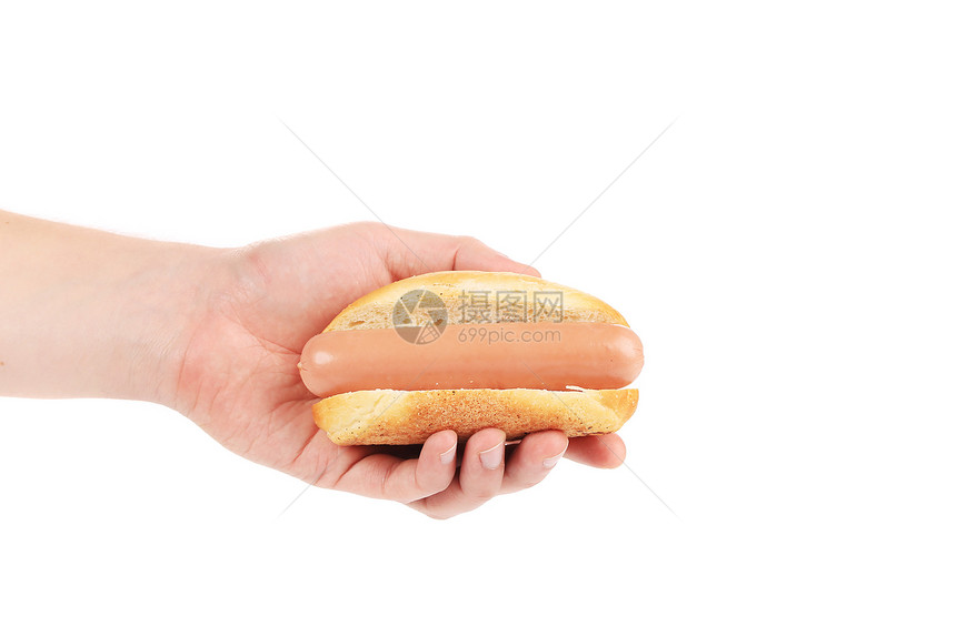 手握着未煮熟的热狗白色宏观食物午餐包子垃圾香肠小吃脂肪面包图片