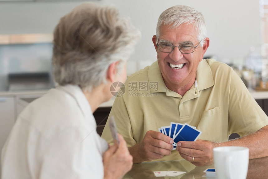 玩牌的老年情侣快乐游戏咖啡退休女性男人头发女士桌子厨房纸牌闲暇图片