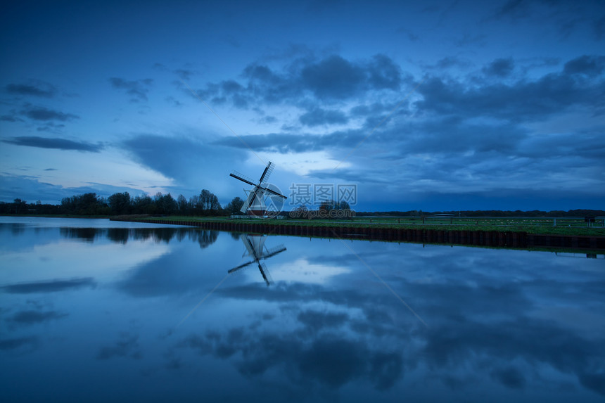 黄昏时 荷兰风车沿河行驶图片
