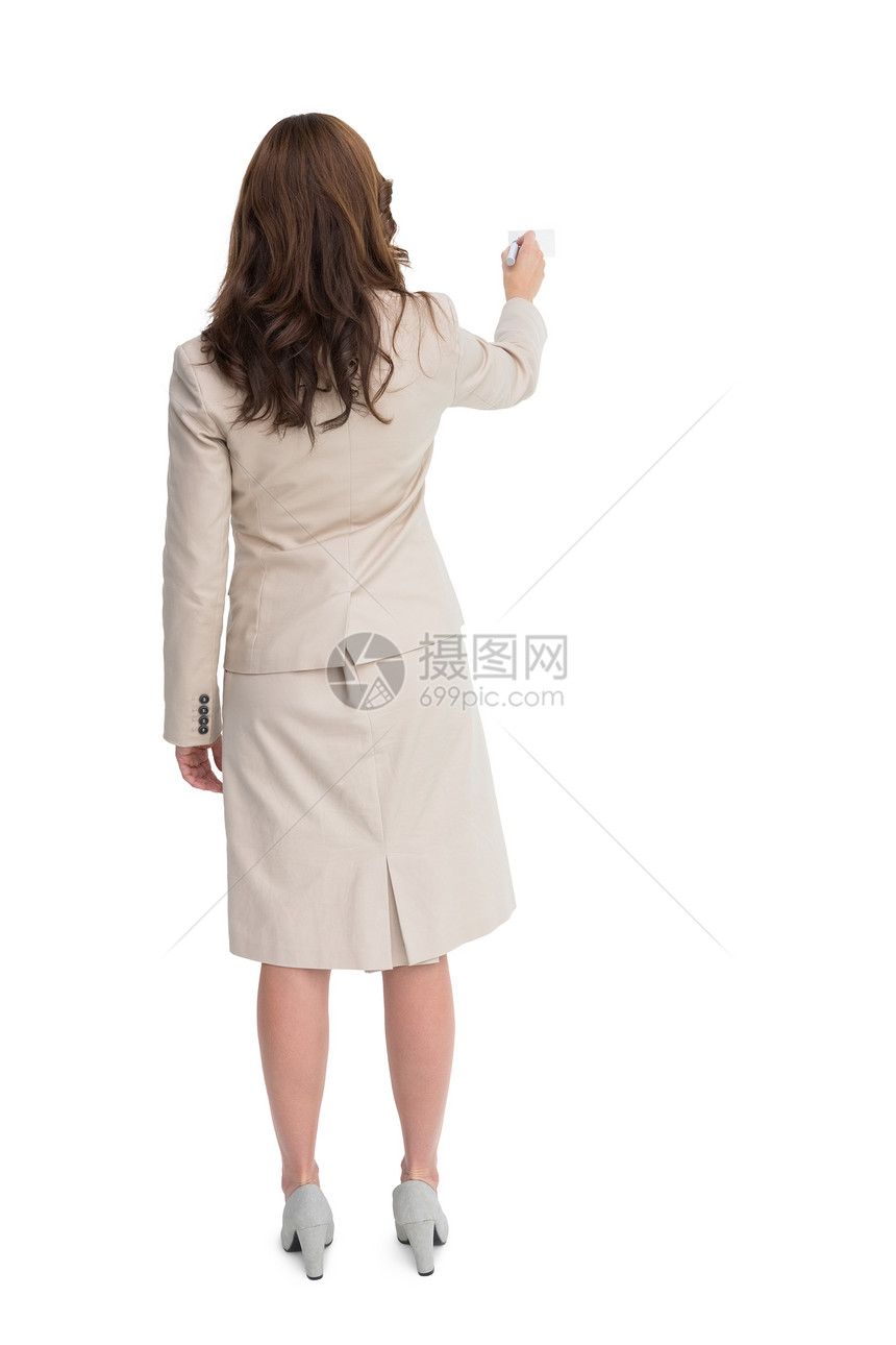 商业女商务人士靠后站着拿着标记的照相机写作图片