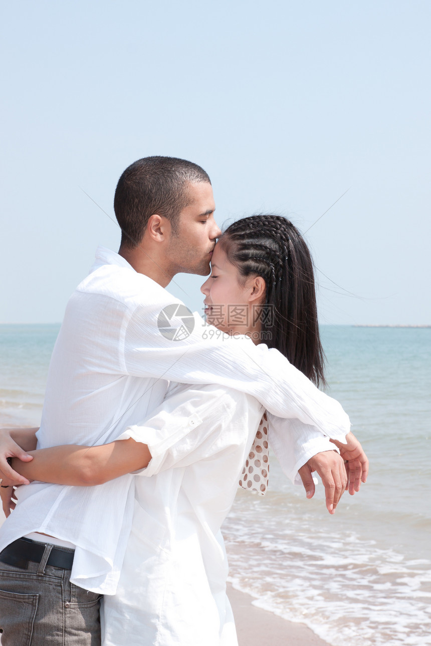 非洲男人和亚洲女人在海滩上的爱人喜悦蓝色男性女性海洋小猪乐趣感情假期女士图片