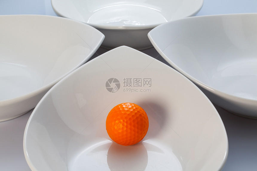 白陶瓷碗和橙黄色高尔夫球材料桌子镜子玻璃橙子烹饪运动食物白色黑色图片